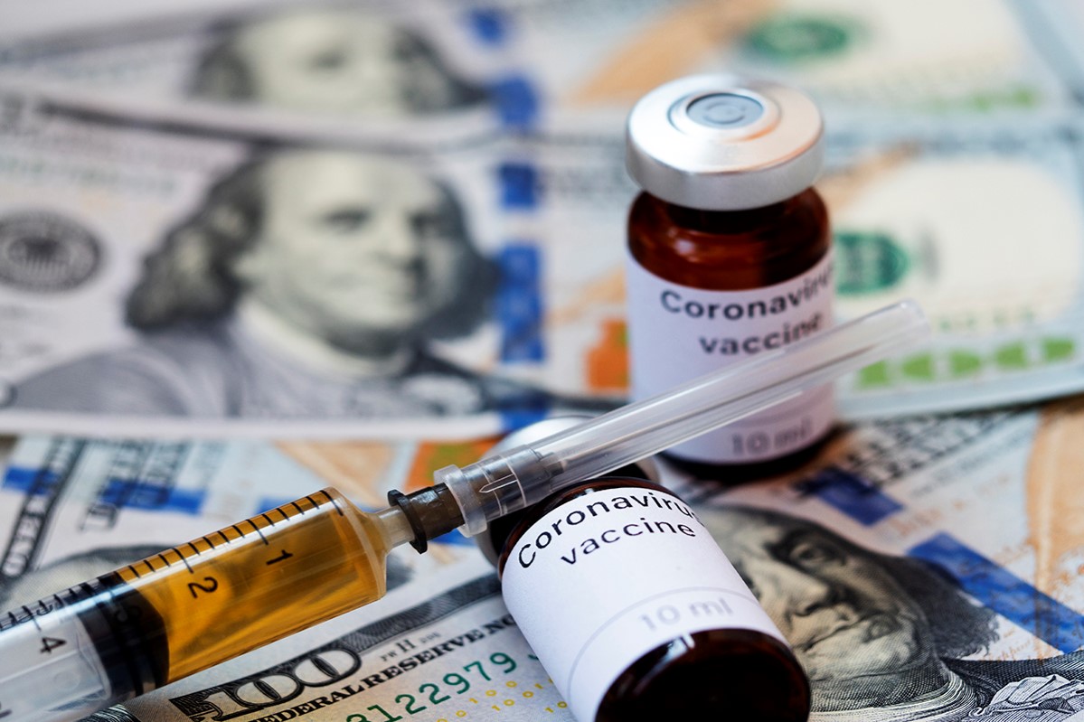 Igor Golovniov / SOPA Images  disease, notes, business, us dollars, covid-19, coronavirus, health, vial, bill, economy, pandemic, virus, covid19, syringe, vaccine, money, coronavirus vaccine, outbreak, bank notes, covid 19, currency, cash, one hundred, corona virus